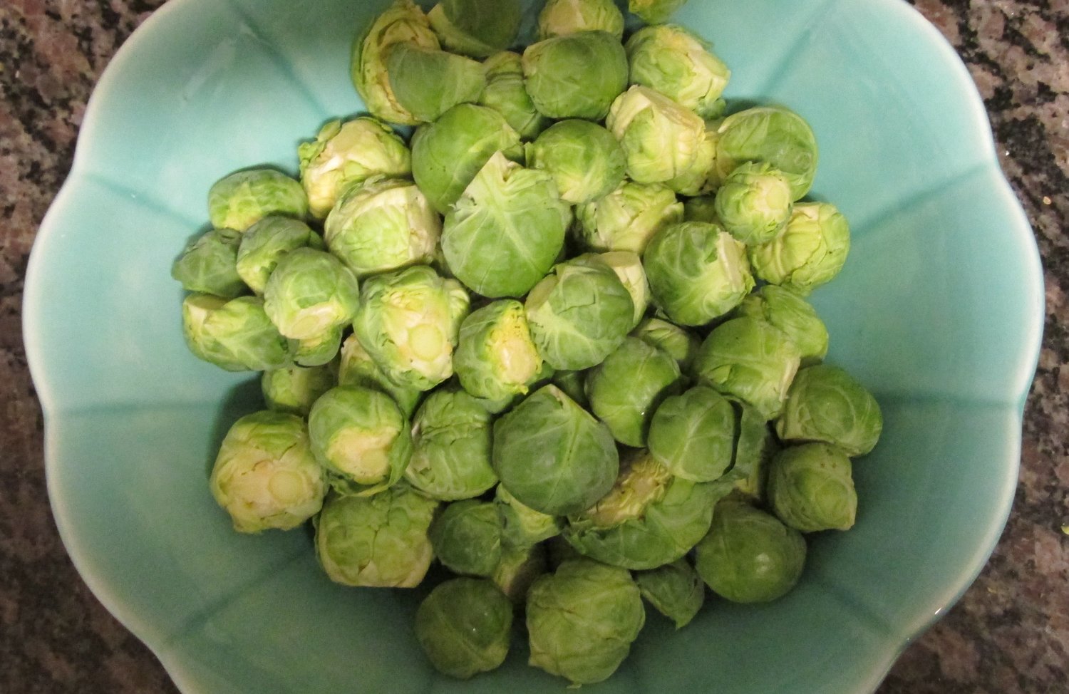 Bowl of  cleaned and trimmed Brussels sprouts.